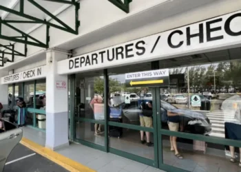 Passengers queue at the departures area during the Industrial Action At Hewanorra Airport, causing major delays and operational disruption.