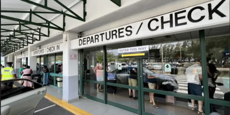Passengers queue at the departures area during the Industrial Action At Hewanorra Airport, causing major delays and operational disruption.