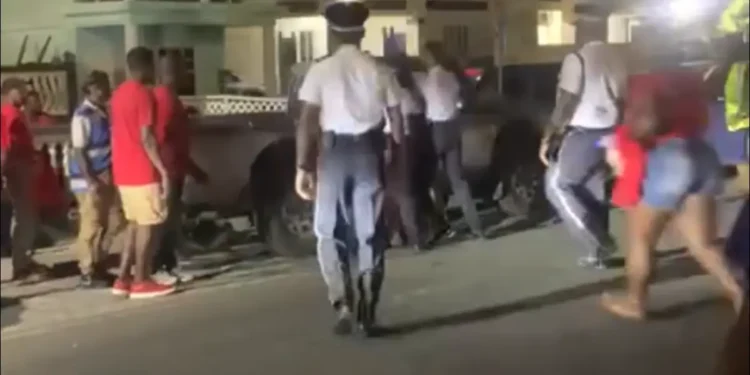 SLP supporters brutally attack police officers in Anse la Raye, shoving and striking uniformed law enforcement during a chaotic meeting.