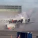 Passengers evacuate onto the wing as an American Airlines plane catches fire at Denver International Airport, with thick smoke filling the air.