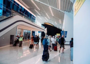 Passengers walking through a newly renovated concourse at Charlotte Douglas Airport near the TSA checkpoint.