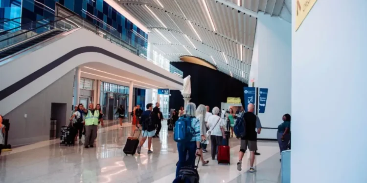 Passengers walking through a newly renovated concourse at Charlotte Douglas Airport near the TSA checkpoint.