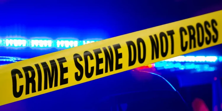 Crime scene with police tape after man killed in Choiseul concrete block attack, with emergency lights flashing in the background.