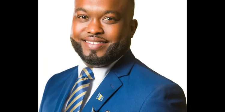 Dale Rowe slams land giveaway in official portrait as DLP candidate for the City of Bridgetown, dressed in a blue suit and striped tie.