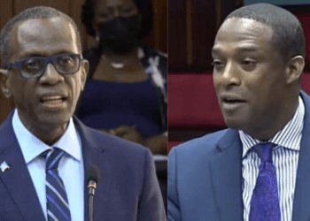 Saint Lucia Prime Minister Philip J. Pierre and Finance Minister Wayne Girard side by side in parliament amid controversy over St Lucia airports foreign control.