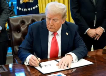 U.S. President Donald Trump signing an executive order in the Oval Office as his new travel ban targets 43 countries, imposing strict immigration restrictions.