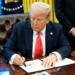 U.S. President Donald Trump signing an executive order in the Oval Office as his new travel ban targets 43 countries, imposing strict immigration restrictions.