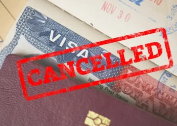 US revokes 300 student visas with a red ‘CANCELLED’ stamp on a US visa, symbolizing a pro-Palestinian crackdown (representational).