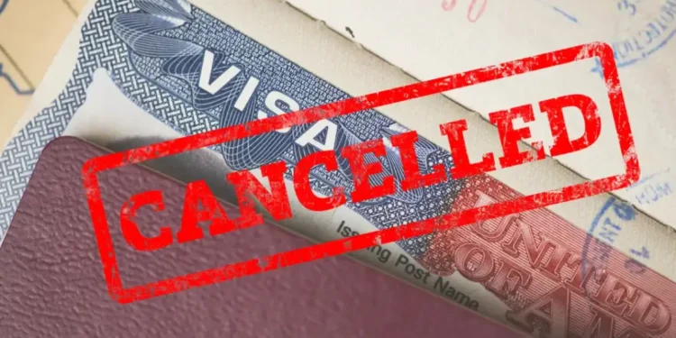 US revokes 300 student visas with a red ‘CANCELLED’ stamp on a US visa, symbolizing a pro-Palestinian crackdown (representational).