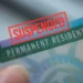 U.S. green card with ‘SUSPENDED’ stamp as US suspends green card processing.