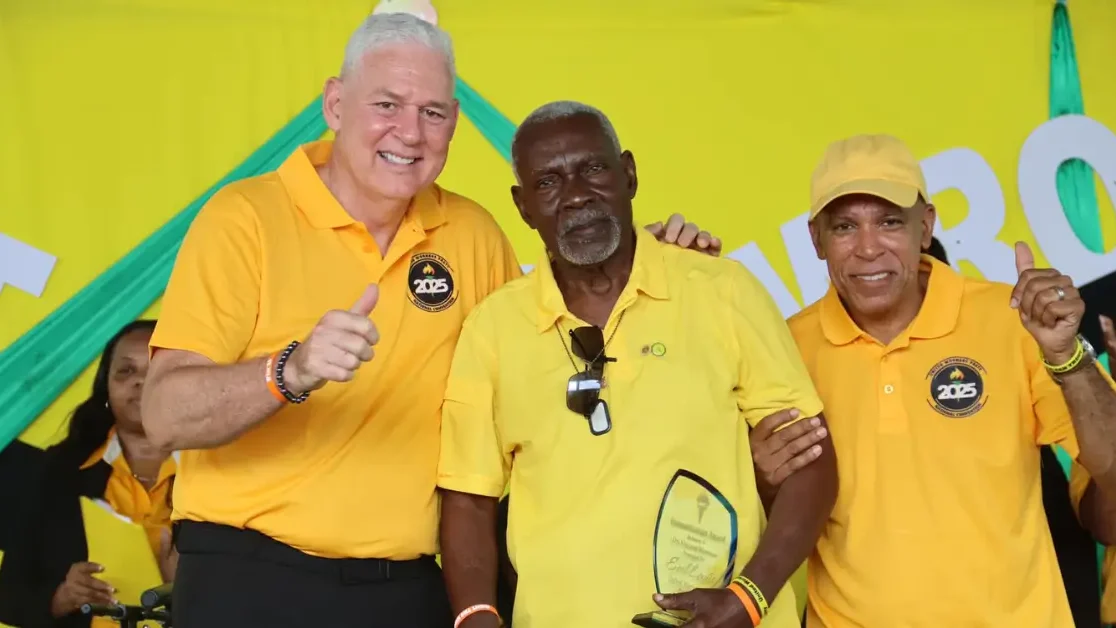 Hon. Allen Chastanet and UWP Chairman present a recognition award to long-standing supporter Mr. Earl Lewis