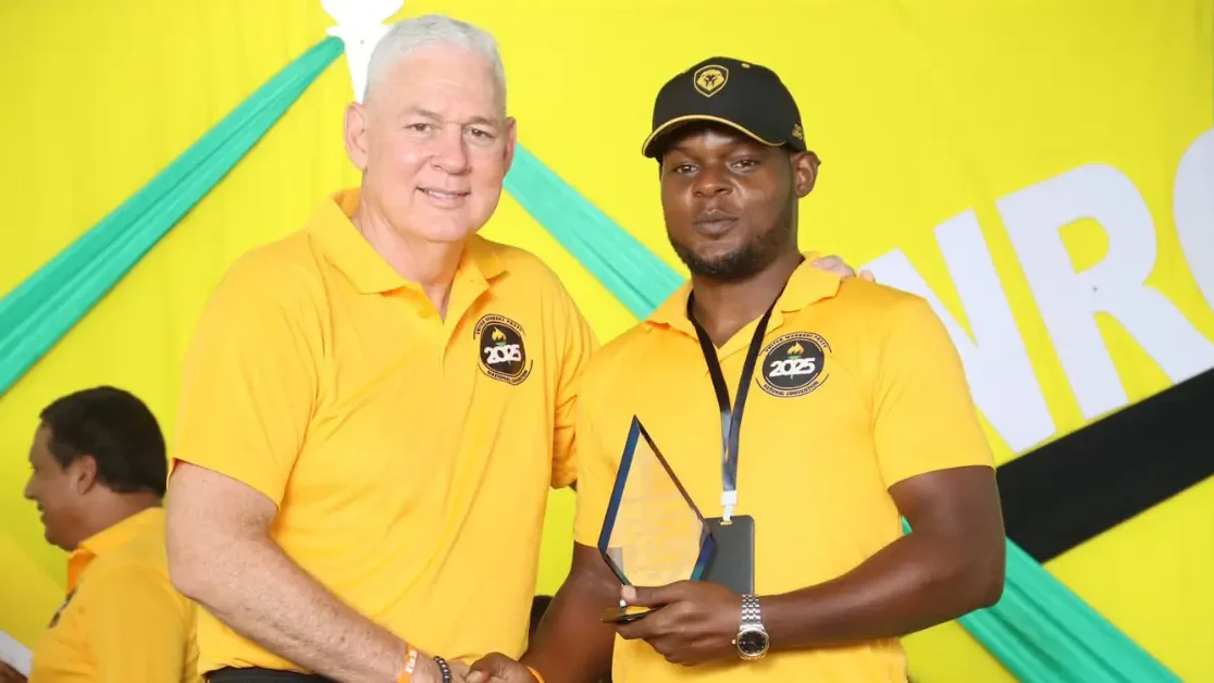 Hon. Allen Chastanet presents an award to a young UWP member accepting on behalf of a long-standing party supporter