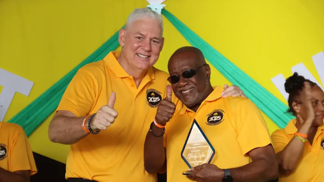 Hon. Allen Chastanet presents an award to Eldridge Stephen