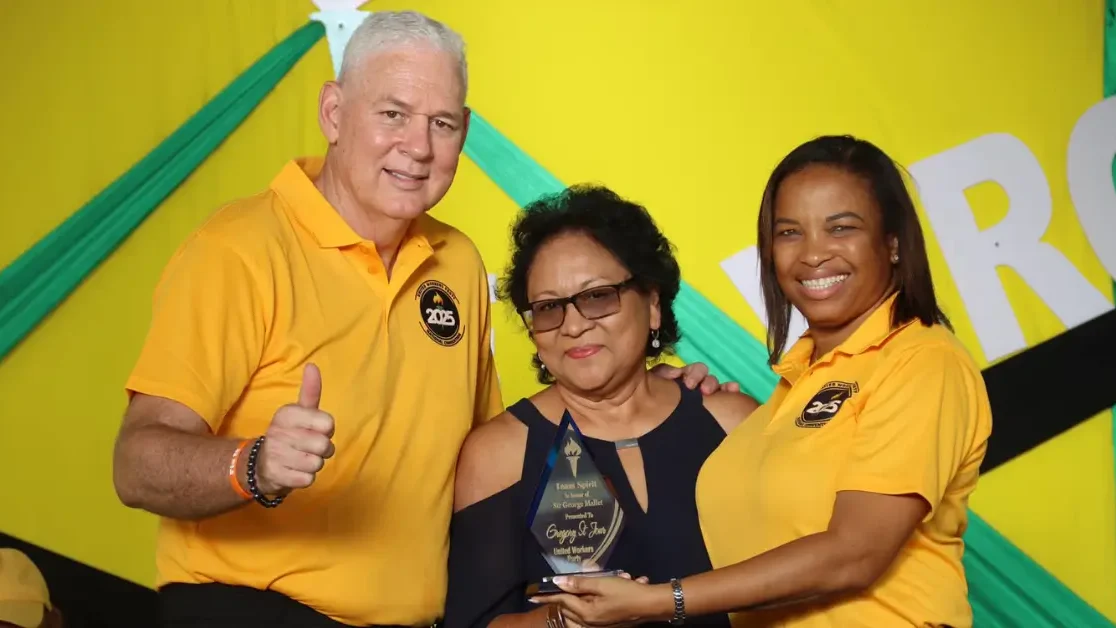 Hon. Allen Chastanet and Marcella Johnson present the Sir George Mallet Team Spirit Award at the UWP Hosts Successful 43rd Convention in St Lucia, recognizing dedication and service