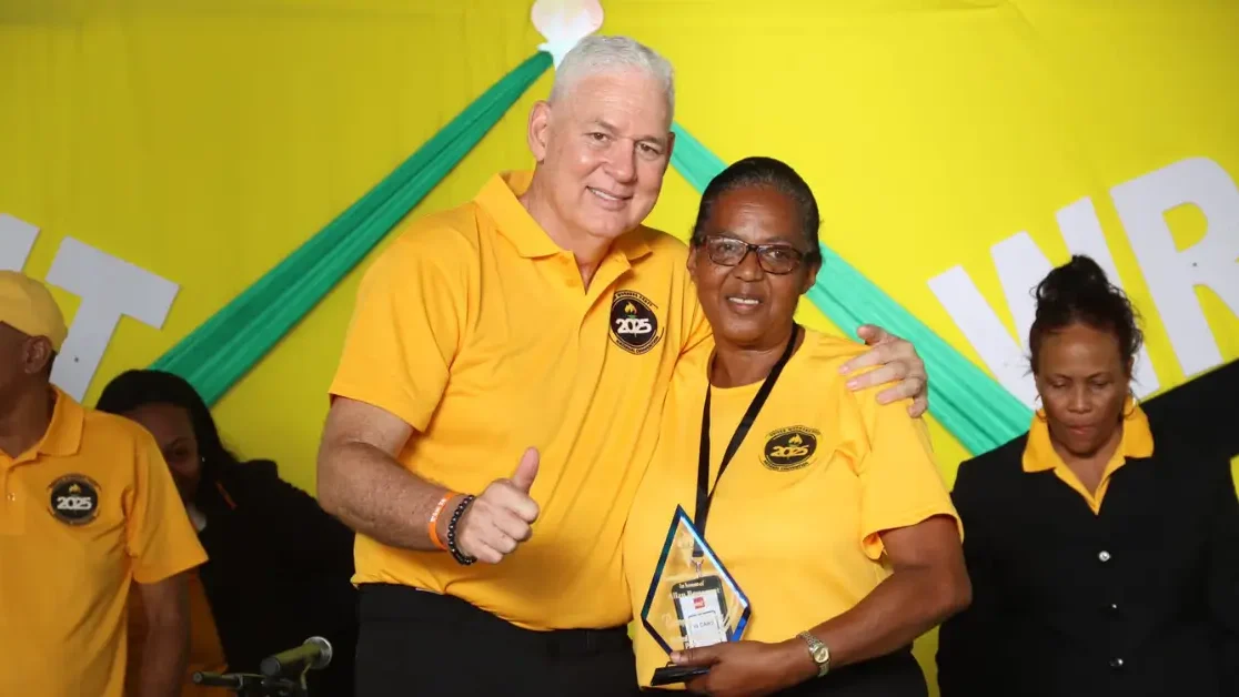 Hon. Allen Chastanet presents an award to a long-serving UWP member at the UWP Hosts Successful 43rd Convention in St Lucia, recognizing dedication and commitment.