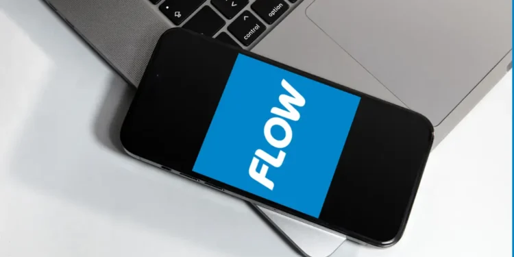 Smartphone displaying Flow logo next to laptop, referencing Flow St Lucia internet price increase.
