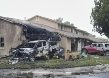 Burned vehicles and a damaged home in Murphy Canyon following the Cessna Citation II crash in San Diego on May 22, 2025.