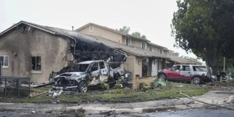 Burned vehicles and a damaged home in Murphy Canyon following the Cessna Citation II crash in San Diego on May 22, 2025.