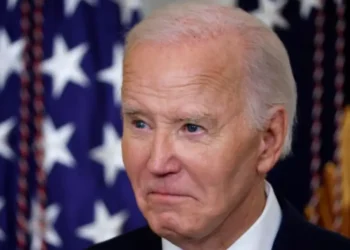 Joe Biden diagnosed with prostate cancer, close-up photo with U.S. flags in background
