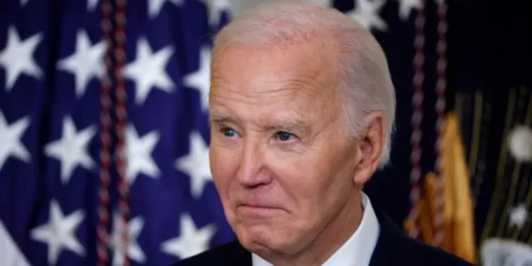 Joe Biden diagnosed with prostate cancer, close-up photo with U.S. flags in background