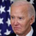 Joe Biden diagnosed with prostate cancer, close-up photo with U.S. flags in background