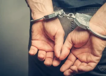 Hands of arrested man in handcuffs after Port Castries drug and gun bust