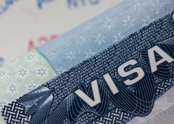 US embassy visa warning over Caribbean birth tourism misuse shown with close-up of visa.