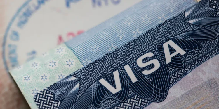 US embassy visa warning over Caribbean birth tourism misuse shown with close-up of visa.