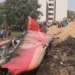 Air India Flight 171 crash wreckage with tail debris and crowd in Ahmedabad