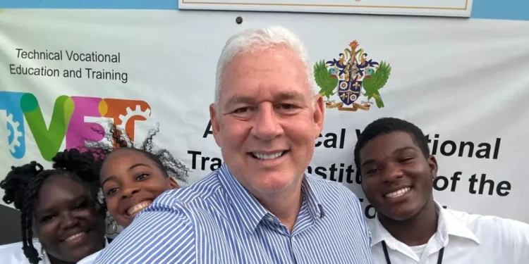 Allen Chastanet takes a photo with students from the St Lucia School of Innovation Class of 2025