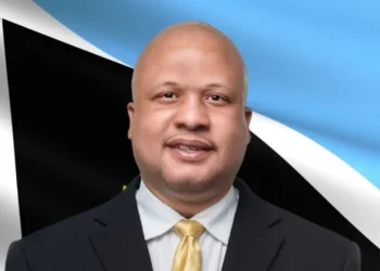 Herod Stanislas, UWP candidate for Soufriere-Fond St Jacques, photographed in front of Saint Lucia flag