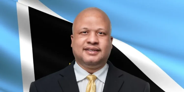 Herod Stanislas, UWP candidate for Soufriere-Fond St Jacques, photographed in front of Saint Lucia flag