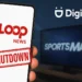 Digicel pulls plug on Loop News with shutdown banner on phone screen, SportsMax logo blurred in background.