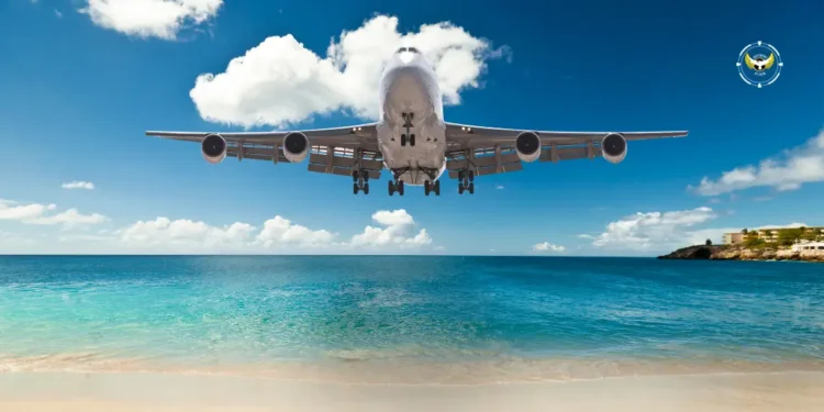 Commercial airplane flying low over Caribbean waters, symbolizing improved Caribbean air connectivity through CTO–ASM partnership