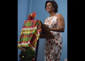 Elma Gene Isaac dies at 60 — pictured delivering an address at a public event draped in Saint Lucian madras
