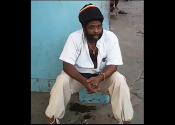 Felix Chucky Leonce seated against a blue wall prior to Leslie Land shooting
