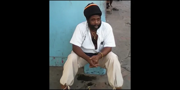 Felix Chucky Leonce seated against a blue wall prior to Leslie Land shooting