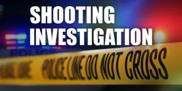 Police crime scene tape with blurred patrol car lights in the background, illustrating Morne Du Don gun attack and shooting investigation in Castries.