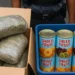 Depiction of Port Castries cannabis seizure with marijuana packages and “dried fruit” tins, August 2025