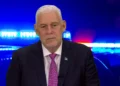 Allen Chastanet addresses the nation on the St Lucia crime crisis with police lights in the background.