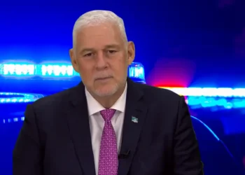 Allen Chastanet addresses the nation on the St Lucia crime crisis with police lights in the background.