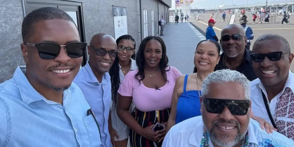 Members of the St Lucia Japan trip entourage smiling for a group photo in Osaka
