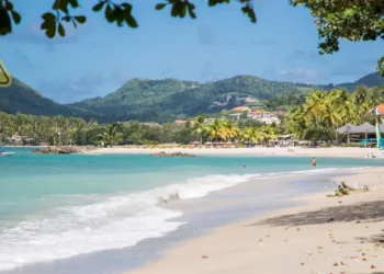 St Lucia weather August 22 2025 showing a Caribbean beach under partly cloudy skies with a tropical wave forecast bringing showers.