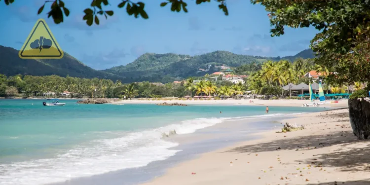 St Lucia weather August 22 2025 showing a Caribbean beach under partly cloudy skies with a tropical wave forecast bringing showers.