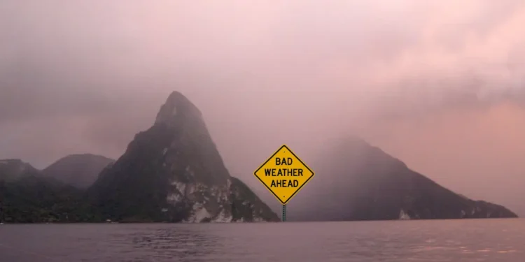 Graphic illustration of the Pitons in St Lucia under stormy skies with a sign reading Bad Weather Ahead for the St Lucia weather August 24 2025 update.