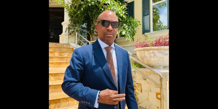 Stephen Fevrier, wearing a blue suit and sunglasses, stands outside a building in Castries after delivering his Stephen Fevrier crime statement on August 19, 2025