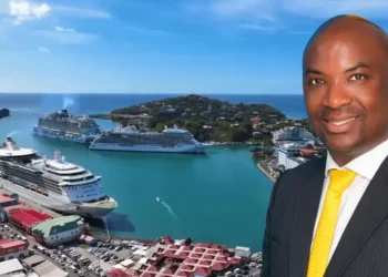 Stephen Fevrier GPH statement: Stephen Fevrier in a suit with a yellow tie, superimposed over Castries harbour with cruise ships docked at Port Castries.