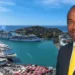 Stephen Fevrier GPH statement: Stephen Fevrier in a suit with a yellow tie, superimposed over Castries harbour with cruise ships docked at Port Castries.
