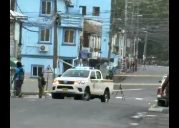 Police vehicle and officers secure the crime scene in Wiltons Yard fatal shooting that left 1 dead and 1 injured in St Lucia.