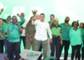Andrew Holness secures third term as JLP wins nail-biting election, celebrating with supporters in Jamaica.